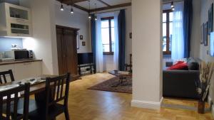 a living room with a kitchen and a dining room at Duomo Classic Apartment in Florence