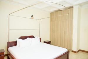 מיטה או מיטות בחדר ב-Kampala Suburbs Apartment