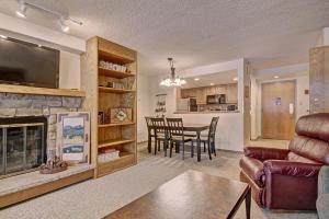 a living room with a fireplace and a dining room at VS643 Square Condo in Copper Mountain