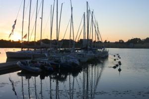 a group of boats docked at a dock in the water at Ranna Villa in Pärnu