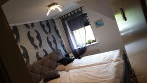 a bedroom with a bed in a room with a window at Dorfkrug Grabau 23845 in Grabau