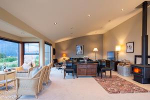 a living room filled with furniture and a fireplace at London Lane in Queenstown