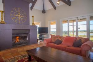 a living room with a couch and a fireplace at Holman Estate in Pokolbin