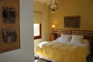 a bedroom with a bed and a picture of a butterfly on the wall at Casa Retama Boutique in Sierra de la Ventana
