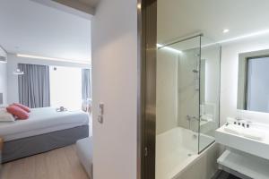 Rúm í herbergi á Messinian Icon Hotel & Suites