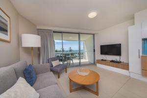 a living room filled with furniture and a tv at Salt Yeppoon in Yeppoon