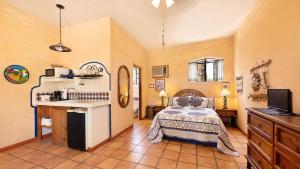 a bedroom with a bed and a sink in a room at Posada del Molino in Todos Santos
