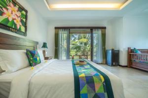 Una cama o camas en una habitación de Gita Maha Ubud Hotel by Mahaputra-CHSE Certified