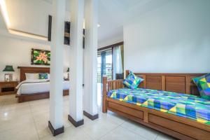 Una cama o camas en una habitación de Gita Maha Ubud Hotel by Mahaputra-CHSE Certified