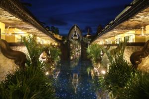 an indoor pool with lights in a resort at night at Sawasdee Village in Kata Beach