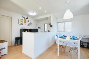 a white kitchen with a white table and chairs at koiwa house 3LDK free wifi free parking in Tokyo