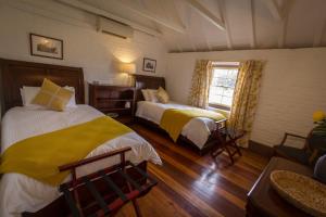 a hotel room with two beds and a window at The Barracks, Tocal in Paterson