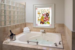 a bath tub in a bathroom with a stained glass window at Wine Country Inn Napa Valley in St. Helena