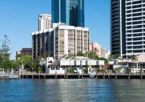 a city with a dock in the water with buildings at Tiki Hotel Apartments Surfers Paradise in Gold Coast