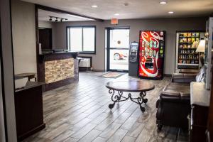 a bar with a soda machine and a table in a room at Super 8 by Wyndham Poplar Bluff Missouri in Poplar Bluff