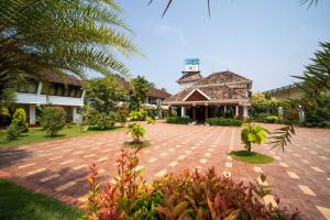 a brick courtyard in front of a building at Nihara Resort and Spa Cochin in Cochin