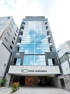 a large building with a large clock on the front of it at hotel androoms Osaka Hommachi in Osaka