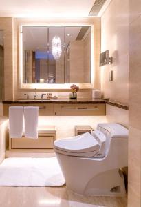 
a bathroom with a toilet, sink and bathtub at IFC Residence in Shanghai
