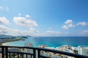 a view of the ocean from the balcony of a condo at Barry Boutique Hotel Sanya in Sanya