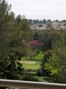 a view of a park with trees and a field at Tee 4 in Nîmes