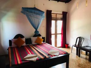 A bed or beds in a room at Sri Beach Bungalows And Villa