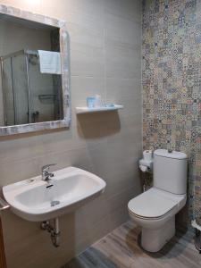 a bathroom with a toilet and a sink at Hotel La Posada in La Palma