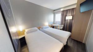 Postel nebo postele na pokoji v ubytování ibis Thonon Centre