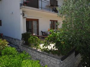 a balcony of a house with a table and chairs at EDITA 2 pax in Crikvenica