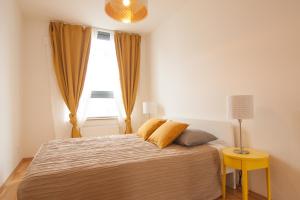 a bedroom with a large bed with a window at Apollo Apartment - Key-Box - Free Parking in Bratislava