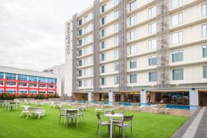 a group of tables and chairs in front of a hotel at Citadines Bay City Manila in Manila