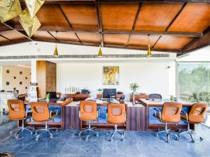 an office with orange chairs and a large desk at Bamboo Saa Resort & Spa - Udaipur in Udaipur +162 photos