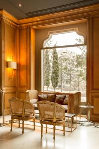 a living room with a couch and a window at Hotel Villa Real, a member of Preferred Hotels & Resorts in Madrid