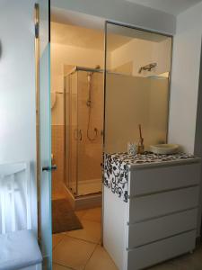 a bathroom with a shower and a white refrigerator at Villa Venino in Moneglia