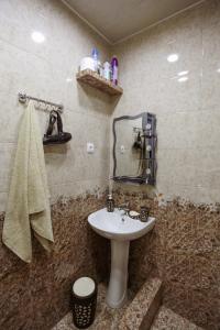 a bathroom with a white sink and a towel at N&N House in Tbilisi City