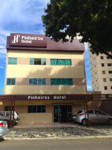 a building with a sign on the front of it at Pinheiros Hotel in Goiânia