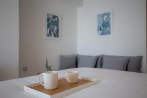 two cups on a wooden tray on a table at Messinian Icon Hotel & Suites in Kalamata