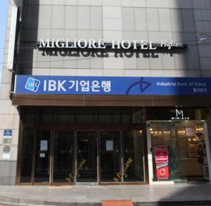 a building with a blue sign on the side of it at Hotel Migliore Seoul in Seoul