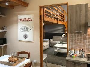 a kitchen and a living room with a loft bed at Casa Mazza in Torre del Greco