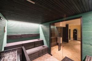 a sauna with wooden benches and a glass door at Grand Hotel Liberty in Riva del Garda