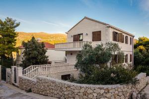 a house with a stone wall in front of it at Astra Villas in Zaton