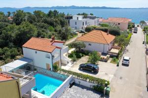 arial view of a house with a swimming pool at Luxury Villa Nada with Pool in Petrcane