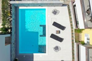 an overhead view of a swimming pool with blue water at Luxury Villa Nada with Pool in Petrcane