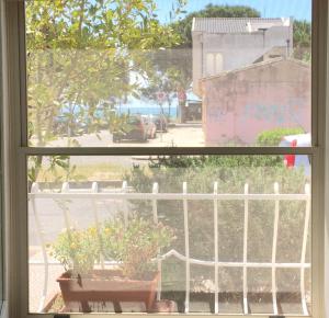 an open window with a view of the beach at Casa Ferreri in Torre Grande