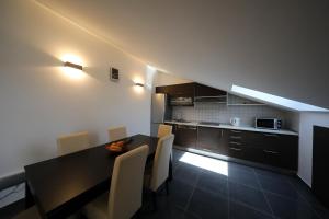 a kitchen with a table and chairs in a room at Luxury Villa Nada with Pool in Petrcane