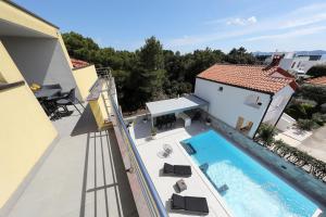 an image of a swimming pool on the balcony of a house at Luxury Villa Nada with Pool in Petrcane