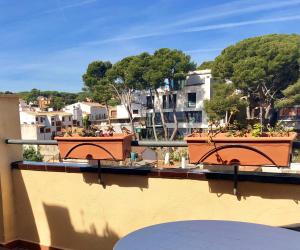 2 ollas en un balcón con vistas a la ciudad en Hotel Montecarlo, en Llafranc