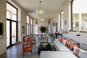 a living room with a couch and chairs and a table at Villa Azir in Ghazoua