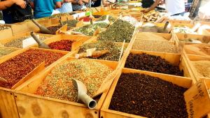 a market with many different types of spices in boxes at Isola Blu in Siracusa +18 photos