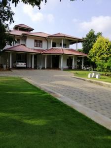 a house with a driveway in front of it at Golden Residence in Anuradhapura