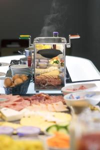a table topped with a variety of food items at Hôtel de l'Europe by HappyCulture in Strasbourg